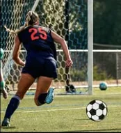Lauren running toward goal during a soccer match
