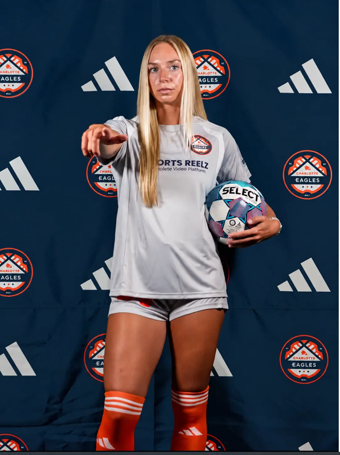 Lauren Walter holding a soccer ball in her Charlotte Eagles uniform