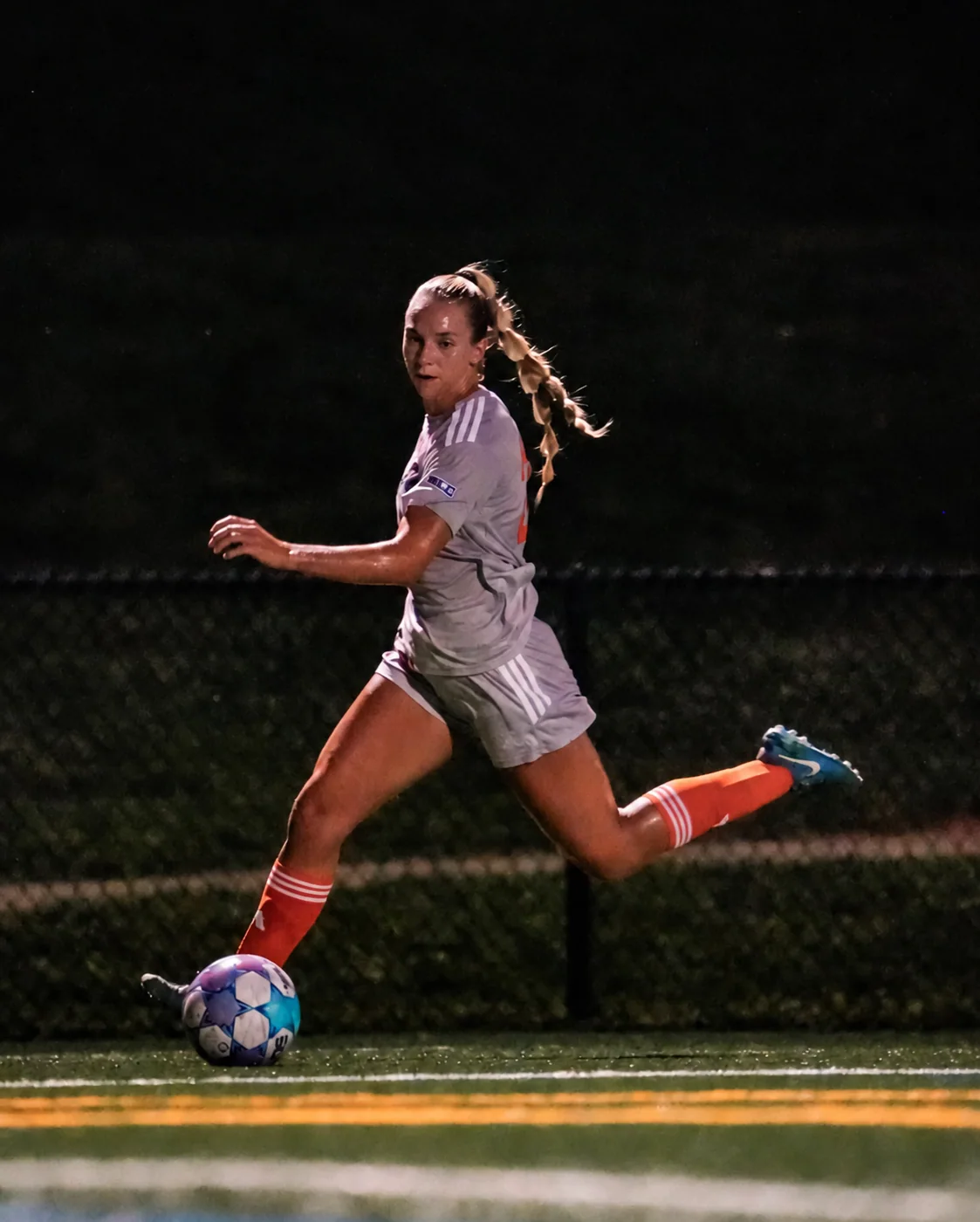 Lauren Walter dribbling the ball at night in her Charlotte Eagles uniform